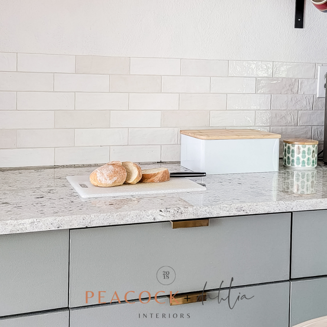 light and airy kitchen with fresh French bread sliced on cutting board