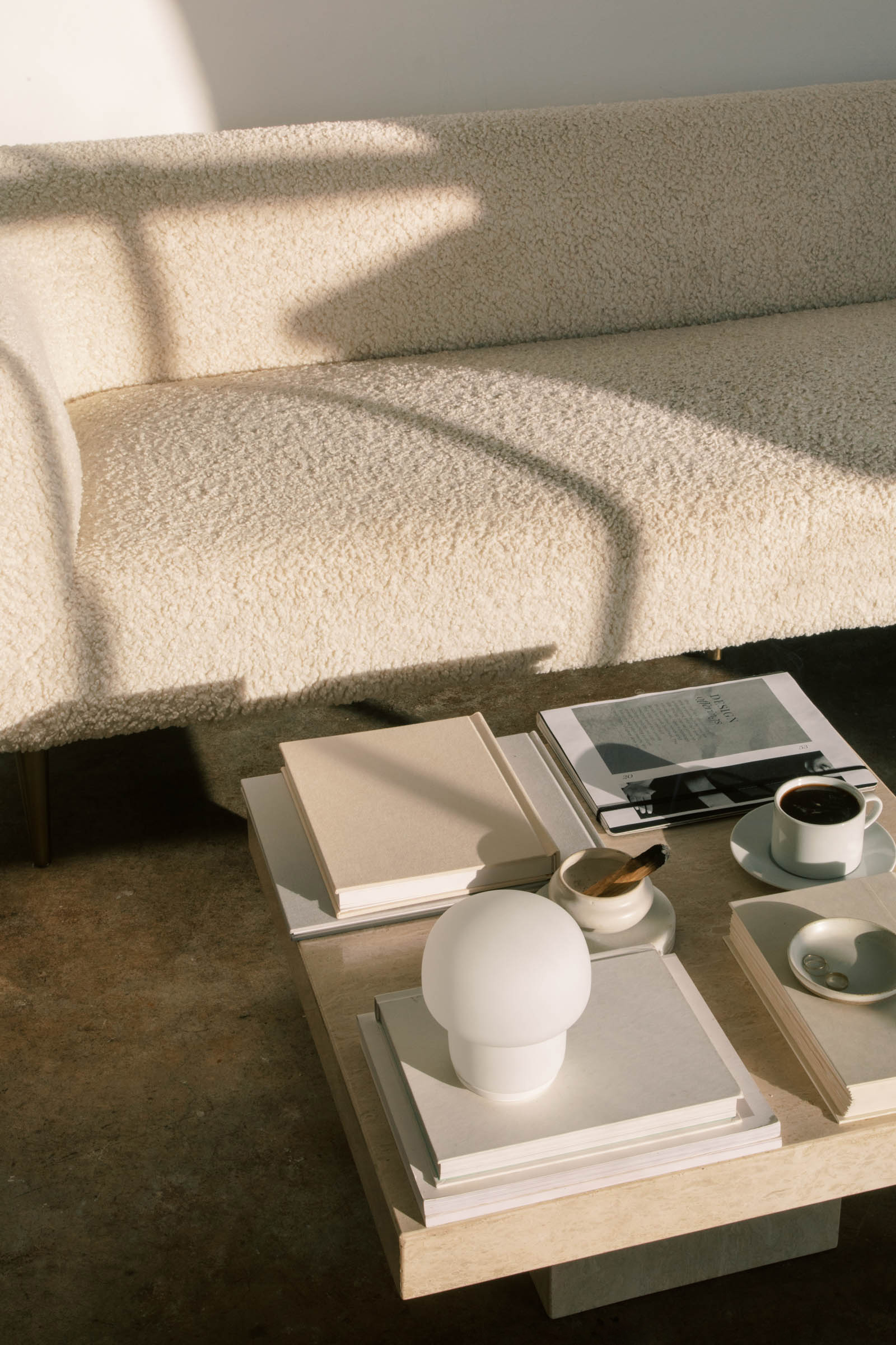 living-room-with-styled-coffee-table-and-soft-natural-light-cream-colored-sofa-with-soft-texture